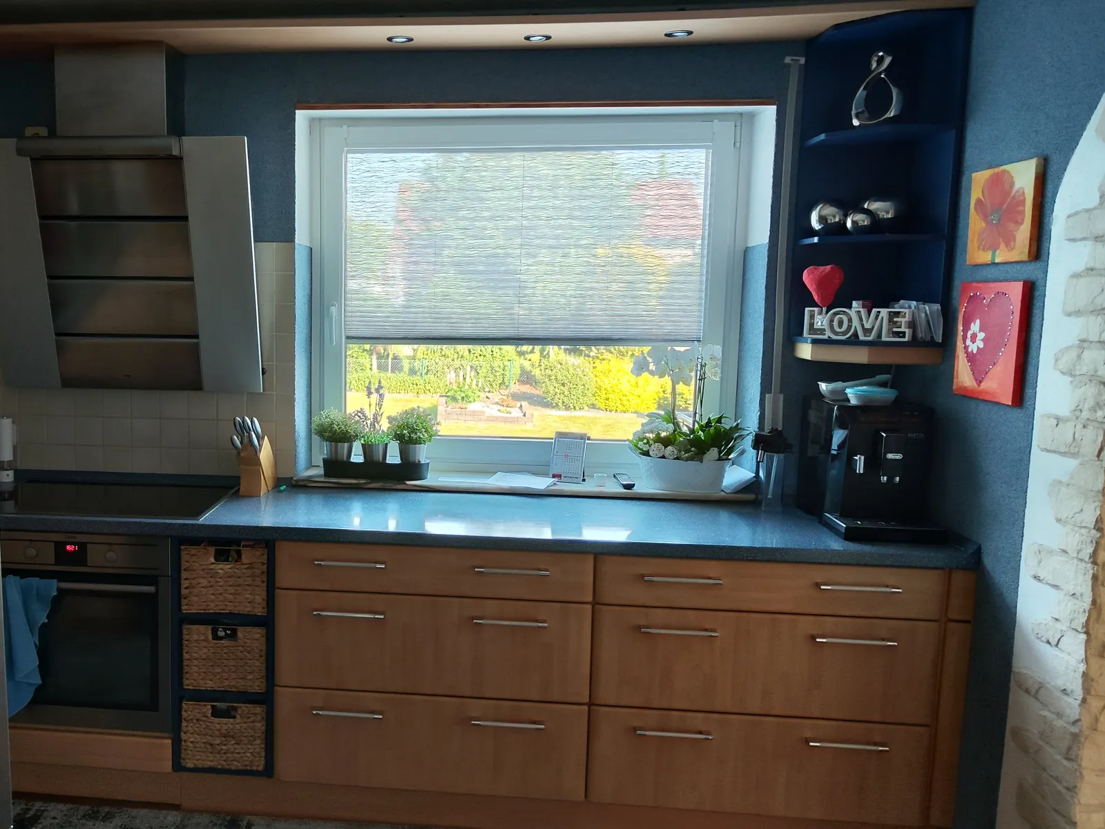Küche vor der Modernisierung mit Buchendekor, Fliesenspiegel und Schräghaube neben dem Fenster